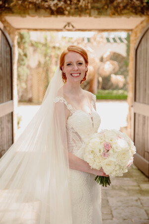 Courtney Ladner Bridal Session at The Bell Tower on 34th, featuring a bride holding a bouquet of white roses in a beautiful bridal gown.